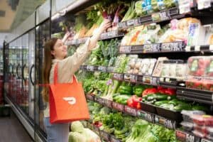 a woman is shopping in a grocery store